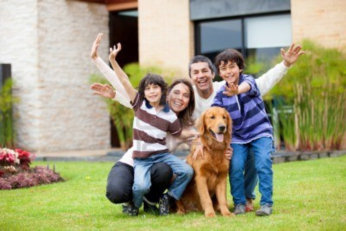 14024356-happy-family-with-a-dog-outside-their-house